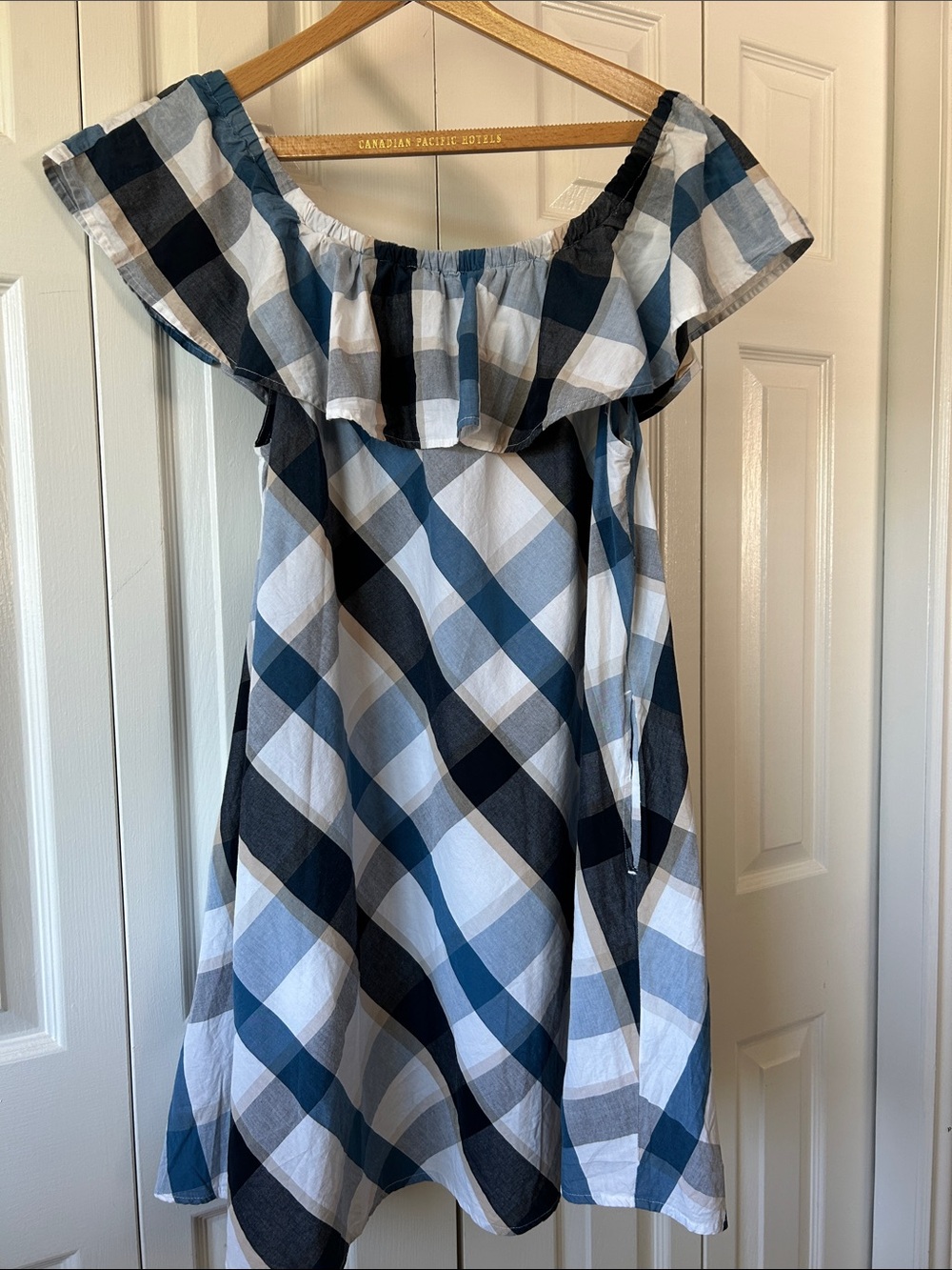100% cotton a line dress with pockets and ruffle neck line. Blue and whit check